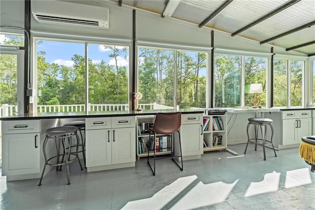 59246 Cypress Bayou Ln, Lacombe, LA 70445 - sunroom / solarium featuring an AC wall unit, healthy amount of natural light, view of wooded area, and vaulted ceiling