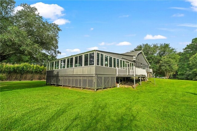 59246 Cypress Bayou Ln, Lacombe, LA 70445 - rear view of property featuring a lawn, a sunroom, and a deck