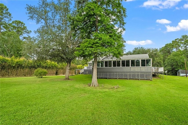 59246 Cypress Bayou Ln, Lacombe, LA 70445 - view of green lawn featuring a sunroom and a deck