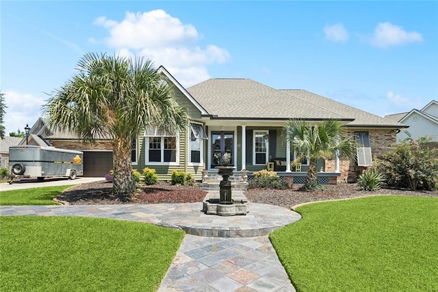 8 Oak Tree Dr, Slidell, LA 70458 - view of front facade featuring a front lawn, covered porch, driveway, french doors, and an attached garage