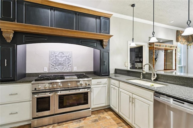 8 Oak Tree Dr, Slidell, LA 70458 - kitchen featuring stainless steel appliances, crown molding, brick patterned flooring, dark stone countertops, and decorative light fixtures
