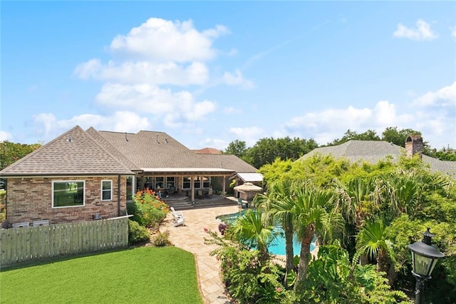 8 Oak Tree Dr, Slidell, LA 70458 - rear view of house with a patio, brick siding, a pergola, a shingled roof, and a chimney