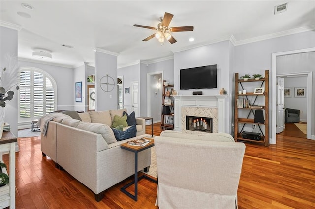 1107 Meadow Ct, Mandeville, LA 70448 - living area with a ceiling fan, a fireplace, wood finished floors, crown molding, and recessed lighting