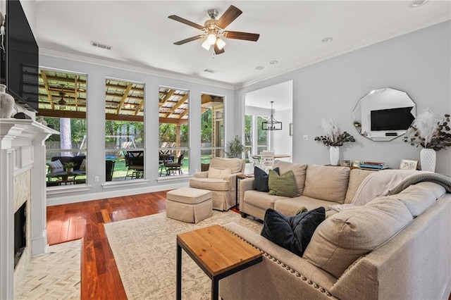 1107 Meadow Ct, Mandeville, LA 70448 - living room featuring a fireplace, a ceiling fan, ornamental molding, and wood finished floors