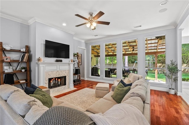 1107 Meadow Ct, Mandeville, LA 70448 - living room featuring ceiling fan, a premium fireplace, wood finished floors, ornamental molding, and recessed lighting