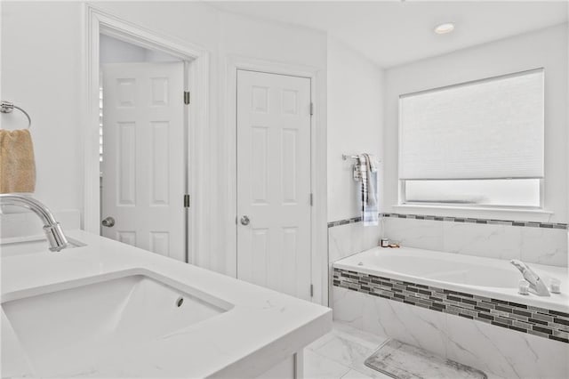 1107 Meadow Ct, Mandeville, LA 70448 - bathroom with a garden tub, marble look tile flooring, and double vanity