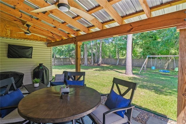 1107 Meadow Ct, Mandeville, LA 70448 - fenced backyard with ceiling fan, a playground, grilling area, and outdoor dining space