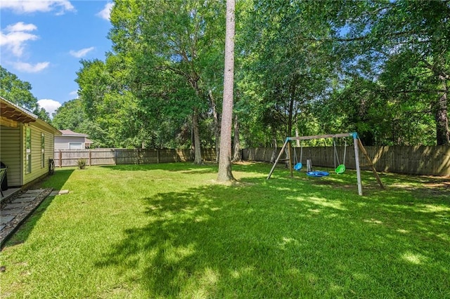 1107 Meadow Ct, Mandeville, LA 70448 - fenced backyard with a playground and view of scattered trees