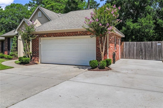 1107 Meadow Ct, Mandeville, LA 70448 - view of front of house with brick siding, driveway, a garage, and a shingled roof