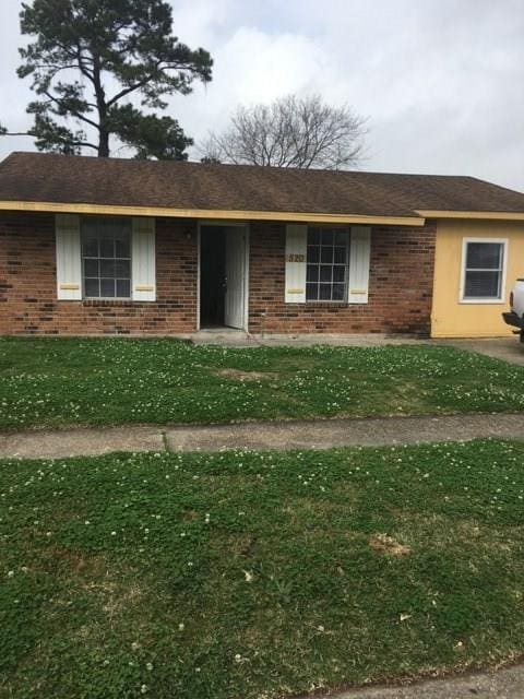 520 Emile Ave, Westwego, LA 70094 - view of front of home with brick siding and a front yard