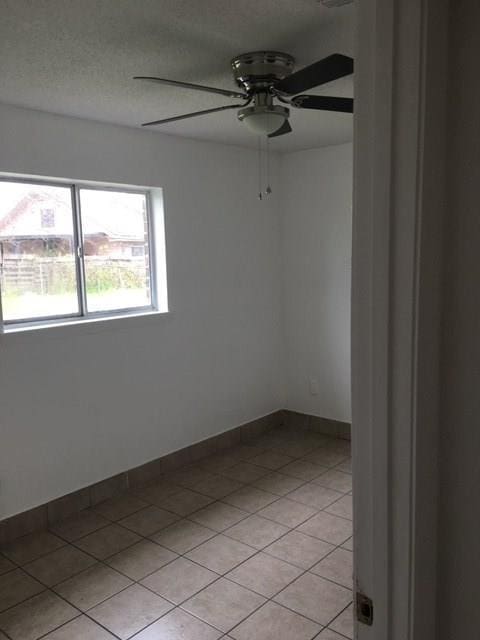 520 Emile Ave, Westwego, LA 70094 - empty room with ceiling fan and light tile patterned flooring