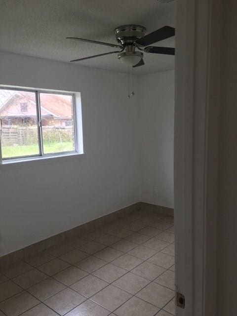 520 Emile Ave, Westwego, LA 70094 - unfurnished room featuring a ceiling fan and light tile patterned floors