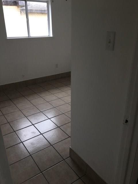 520 Emile Ave, Westwego, LA 70094 - spare room featuring light tile patterned flooring and baseboards