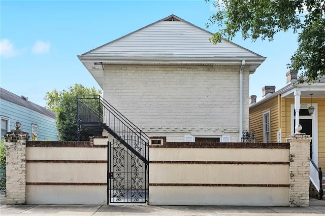 257 Cherokee St Unit 3, New Orleans, LA 70118 - view of front of house with a gate and brick siding