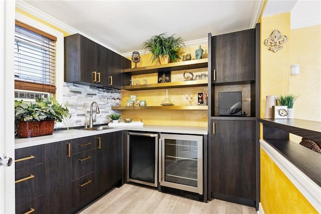 257 Cherokee St Unit 3, New Orleans, LA 70118 - indoor wet bar featuring wine cooler, light wood-type flooring, tasteful backsplash, and ornamental molding