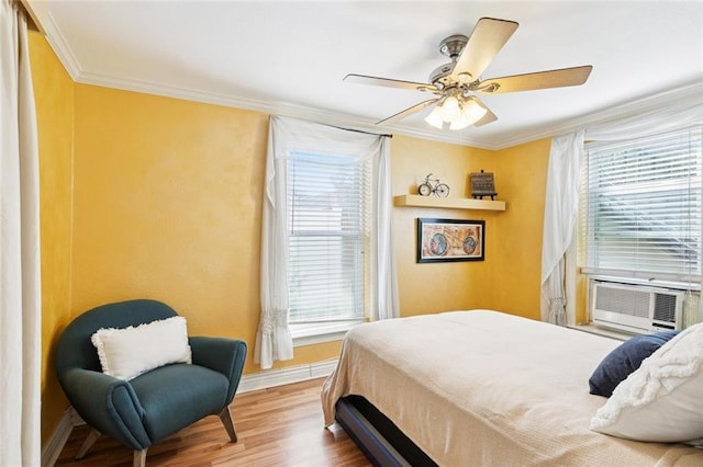 257 Cherokee St Unit 3, New Orleans, LA 70118 - bedroom featuring ornamental molding, wood finished floors, ceiling fan, and cooling unit