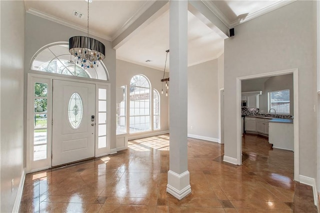 2212 Prairie Ct, Mandeville, LA 70448 - entrance foyer featuring a chandelier, crown molding, and a high ceiling
