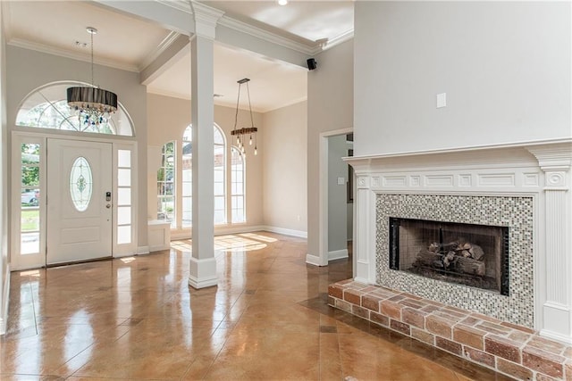 2212 Prairie Ct, Mandeville, LA 70448 - entryway featuring a chandelier, decorative columns, plenty of natural light, crown molding, and a high ceiling