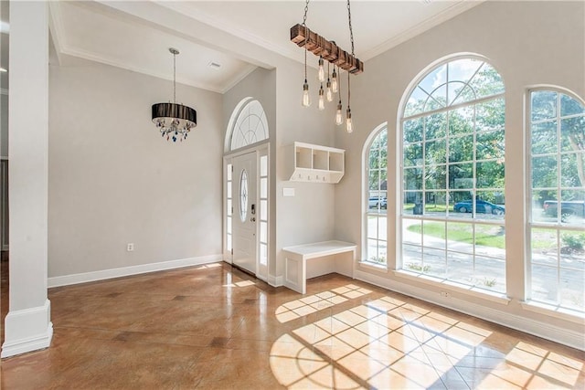 2212 Prairie Ct, Mandeville, LA 70448 - entryway with plenty of natural light, crown molding, a towering ceiling, a chandelier, and inlaid floor details