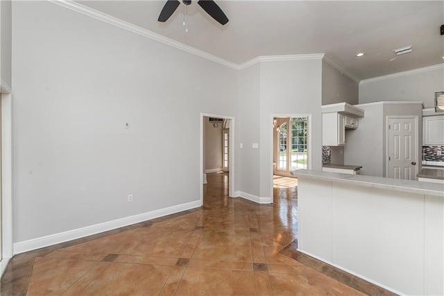 2212 Prairie Ct, Mandeville, LA 70448 - kitchen with ceiling fan, crown molding, light countertops, a towering ceiling, and white cabinets