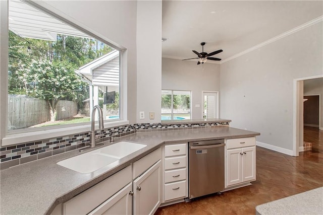 2212 Prairie Ct, Mandeville, LA 70448 - kitchen featuring dishwasher, decorative backsplash, white cabinetry, a peninsula, and ornamental molding