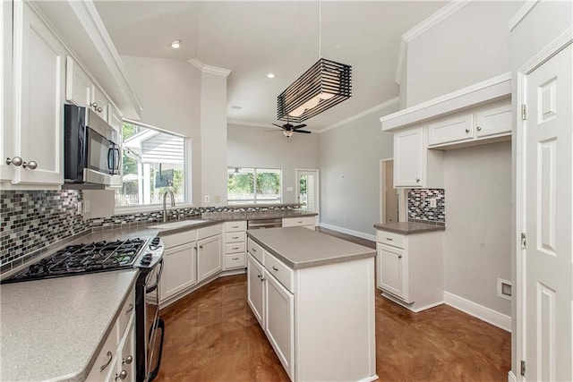 2212 Prairie Ct, Mandeville, LA 70448 - kitchen featuring stainless steel appliances, finished concrete flooring, tasteful backsplash, ceiling fan, and crown molding