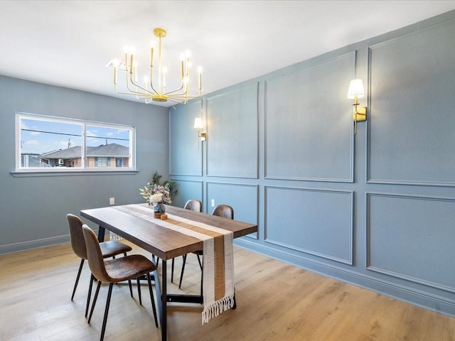 1340 Nursery Pl, Metairie, LA 70005 - dining space with a decorative wall, a chandelier, and light wood-style floors