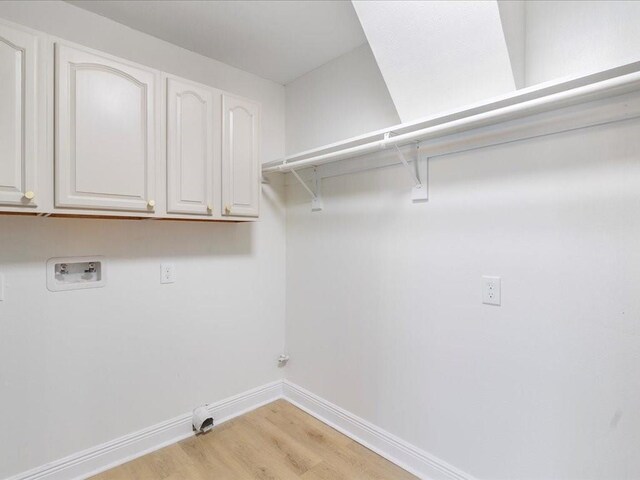 1340 Nursery Pl, Metairie, LA 70005 - laundry area with hookup for a washing machine, gas dryer hookup, light wood-style floors, and cabinet space