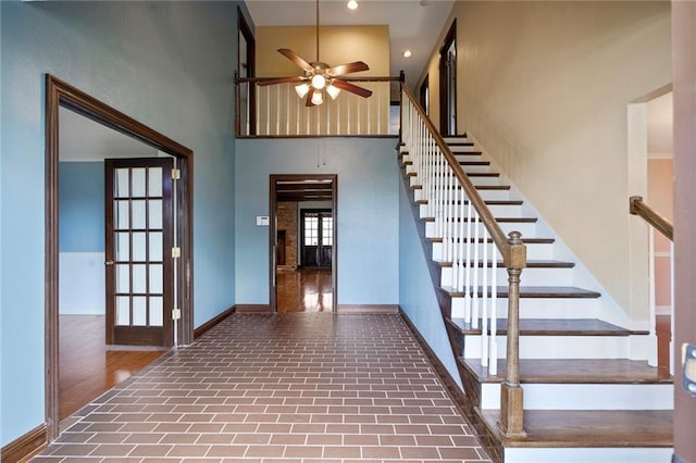 3541 Alan St, Metairie, LA 70002 - staircase featuring brick patterned floors, a ceiling fan, a high ceiling, and recessed lighting