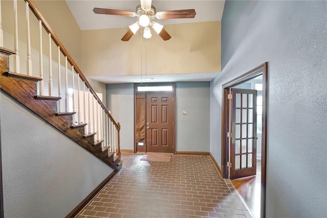3541 Alan St, Metairie, LA 70002 - foyer entrance with brick floors, healthy amount of natural light, ceiling fan, stairway, and a textured wall