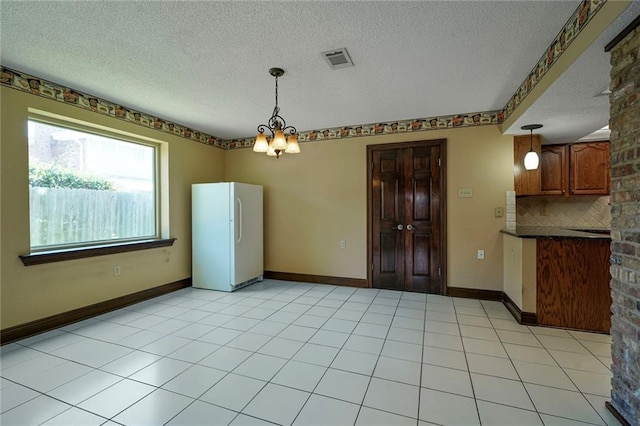 3541 Alan St, Metairie, LA 70002 - unfurnished dining area featuring a textured ceiling and a chandelier