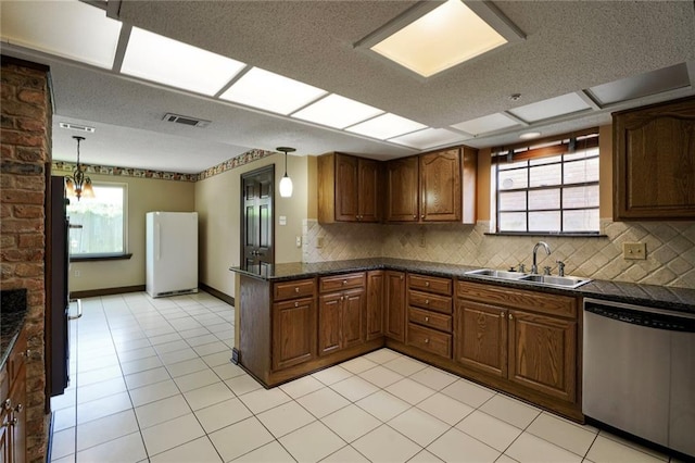 3541 Alan St, Metairie, LA 70002 - kitchen with dishwasher, freestanding refrigerator, dark countertops, and plenty of natural light