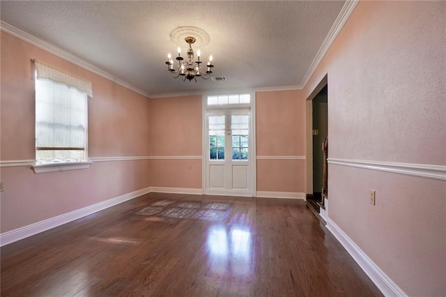 3541 Alan St, Metairie, LA 70002 - unfurnished dining area with a chandelier, wood finished floors, ornamental molding, and a textured ceiling