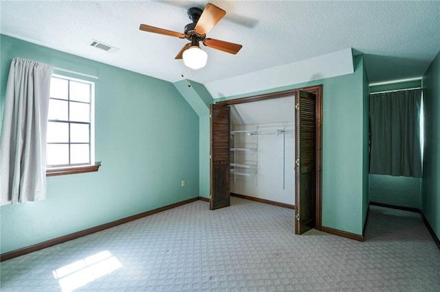 3541 Alan St, Metairie, LA 70002 - unfurnished bedroom with a closet, carpet flooring, a textured ceiling, a ceiling fan, and vaulted ceiling