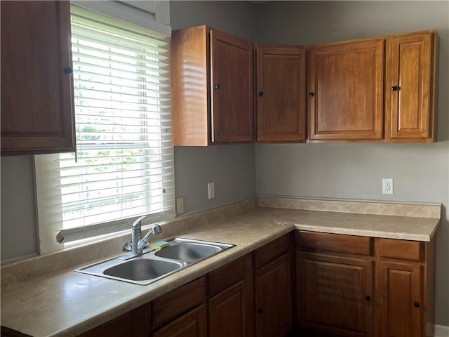 5328 Eastern St, New Orleans, LA 70122 - kitchen with brown cabinetry, plenty of natural light, and light countertops