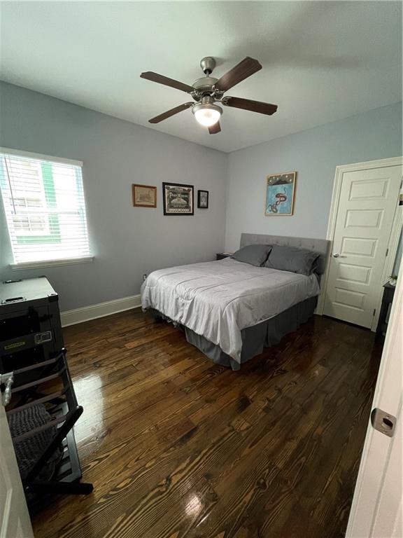 2272 N Robertson St, New Orleans, LA 70117 - bedroom with dark wood-style floors and a ceiling fan