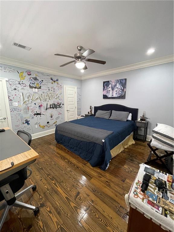 2272 N Robertson St, New Orleans, LA 70117 - bedroom featuring dark wood finished floors, crown molding, a desk, and ceiling fan