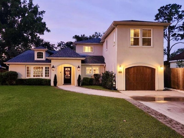9 Hennessey Ct, River Ridge, LA 70123 - view of front of house featuring stucco siding, driveway, and an attached garage