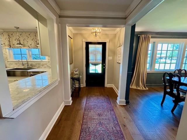 9 Hennessey Ct, River Ridge, LA 70123 - foyer entrance with dark wood finished floors, crown molding, and a chandelier
