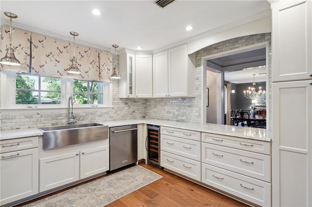 9 Hennessey Ct, River Ridge, LA 70123 - kitchen featuring wine cooler, dishwasher, white cabinetry, backsplash, and ornamental molding