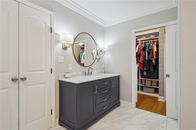 9 Hennessey Ct, River Ridge, LA 70123 - bathroom featuring crown molding, vanity, marble finish floors, and a walk in closet
