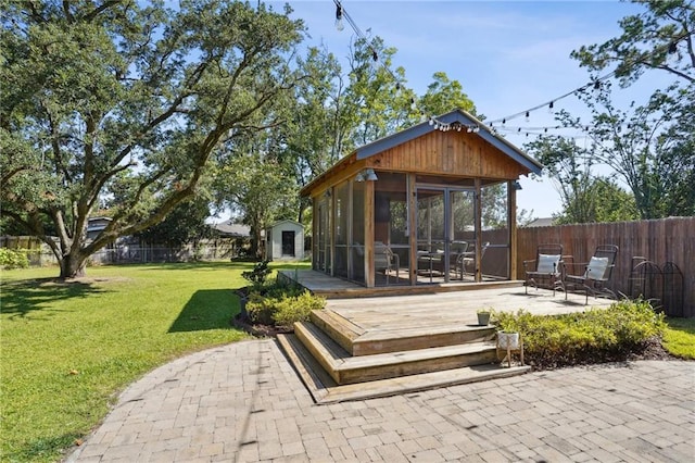 9 Hennessey Ct, River Ridge, LA 70123 - fenced backyard with a sunroom, a shed, a patio area, and a wooden deck
