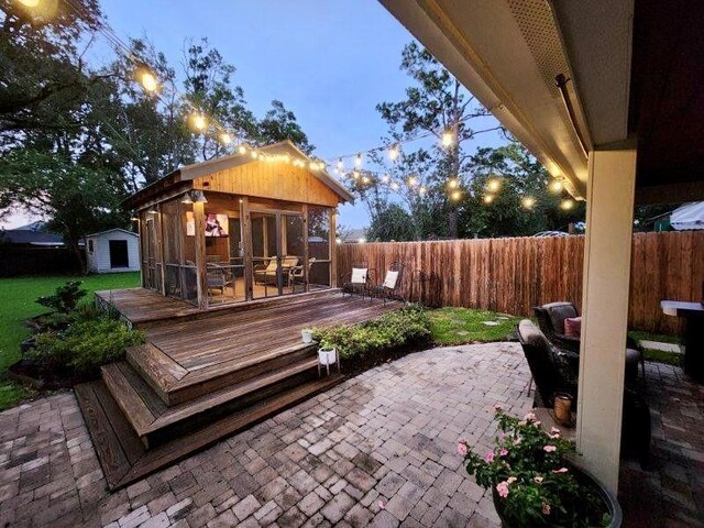 9 Hennessey Ct, River Ridge, LA 70123 - deck featuring a fenced backyard, a patio, and a storage unit