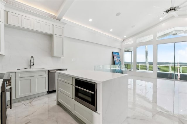 8116 Breakwater Dr, New Orleans, LA 70124 - kitchen with appliances with stainless steel finishes, light marble finish floors, vaulted ceiling, light countertops, and recessed lighting