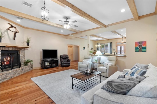 28 Hyacinth Dr, Covington, LA 70433 - living area with beam ceiling, wood finished floors, a brick fireplace, a ceiling fan, and recessed lighting