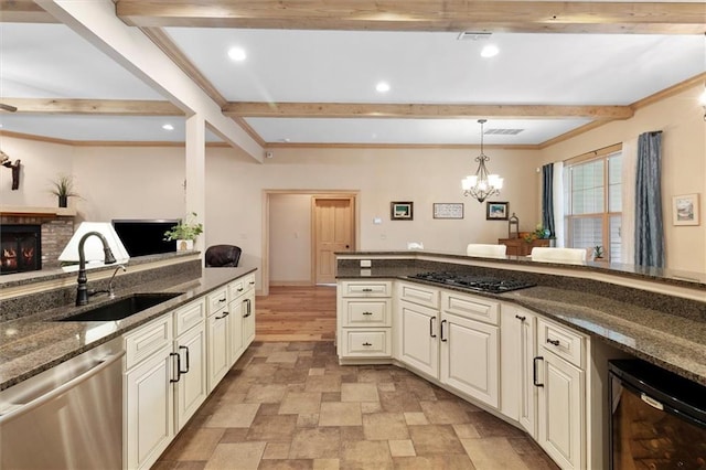 28 Hyacinth Dr, Covington, LA 70433 - kitchen with dishwasher, black stovetop, beam ceiling, beverage cooler, and a chandelier