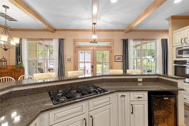 28 Hyacinth Dr, Covington, LA 70433 - kitchen featuring stainless steel appliances, beamed ceiling, beverage cooler, decorative light fixtures, and french doors