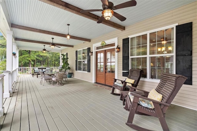 28 Hyacinth Dr, Covington, LA 70433 - wooden porch with french doors, ceiling fan, and outdoor dining area