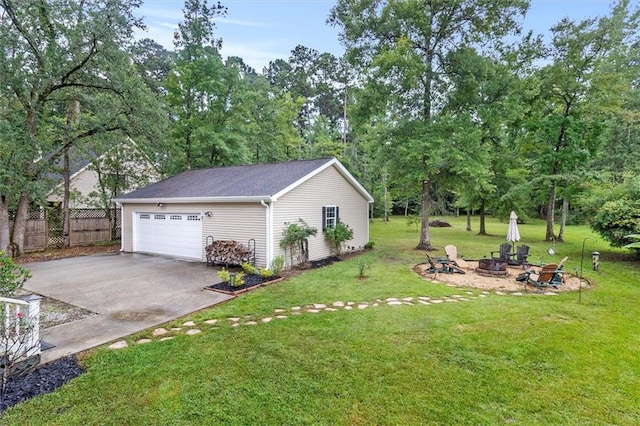 28 Hyacinth Dr, Covington, LA 70433 - view of yard featuring an outdoor fire pit, a garage, driveway, an outbuilding, and view of scattered trees