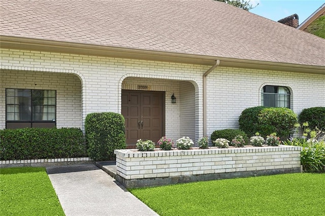3709 Metairie Hts, Metairie, LA 70002 - property entrance with a shingled roof, brick siding, and a yard